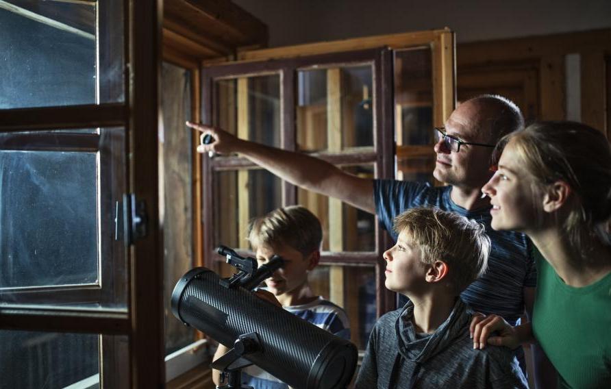 Family using a telescope