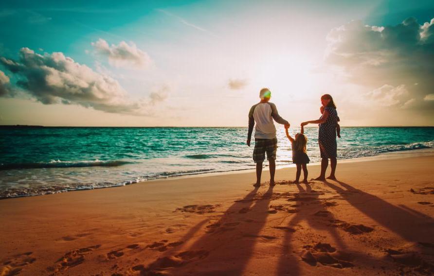 Family on a beach at sunset